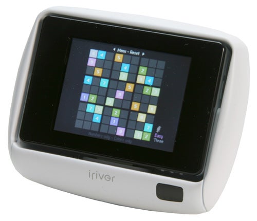iRiver U10 digital media player displaying colorful puzzle game on its screen with the brand name visible on the front casing.