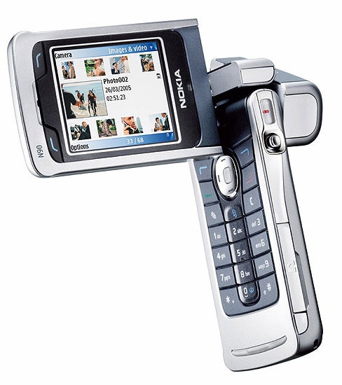 Nokia N90 mobile phone with a swivel screen displaying images and videos, and a visible camera on the back of the screen.