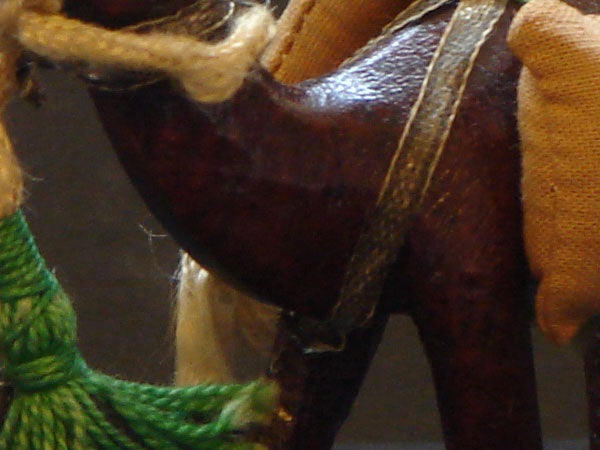 Close-up of a miniature horse figurine's textured details.