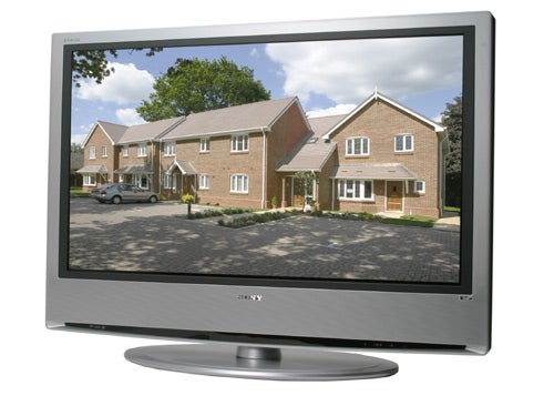 Sony Bravia KDLS40A12U LCD television displaying a clear image of houses on a suburban street, positioned on a stand with the Sony logo visible below the screen.