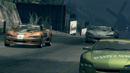 Three sports cars racing on a mountain road in Ridge Racer 6 video game with branding decals and a visible race position indicator.