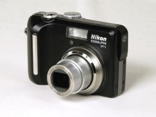 Nikon CoolPix P1 Wi-Fi compact digital camera with lens extended on a white background.