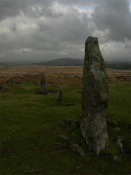 Standing stone in a moorland landscape under an overcast sky, likely taken with a Nikon CoolPix P1 showing the camera's capability to capture outdoor scenes with natural lighting.