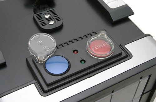 Close-up view of the Cooler Master Ammo 533 computer case's front panel, featuring power and reset buttons with LED indicators.