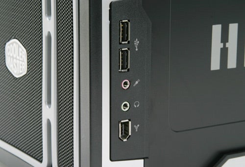 Close-up view of the front panel on a Cooler Master Ammo 533 computer case, showing two USB ports, microphone and headphone jacks, and a firewire port with the Cooler Master logo visible on the left.
