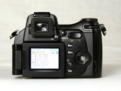Nikon CoolPix 8800 digital camera displayed with LCD screen showing ISO sensitivity settings menu.