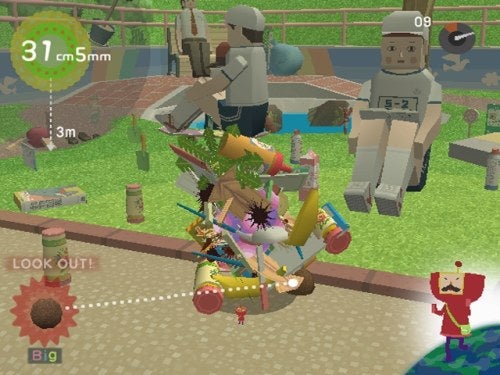 Screenshot from the video game 'We Love Katamari' showing a colorful cluster of objects being rolled into a ball with a size indicator on the upper left and game characters in the background.