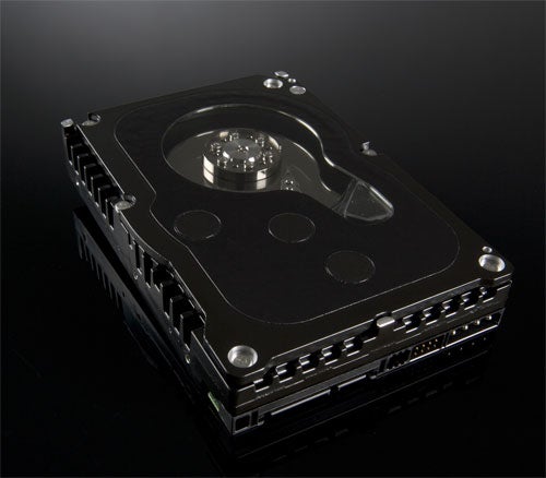 Western Digital WD1500ADFD Raptor Hard Disk displayed on a reflective surface showcasing its black top cover and unique design.