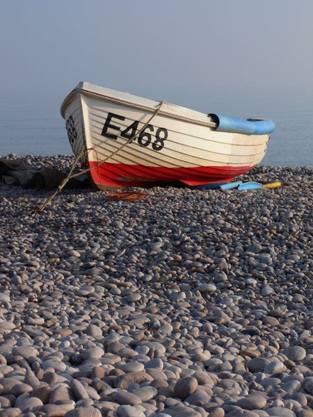 A small red and white boat with registration 