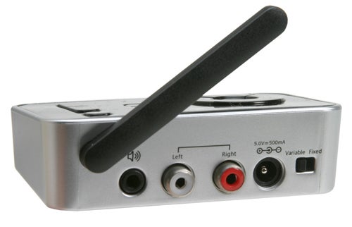 Logitech Wireless Music System transmitter with antenna extended, volume knob, and various audio input/output ports displayed.