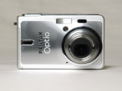 A Pentax Optio S6 compact digital camera positioned against a neutral background with its lens and flash visible at the front, and the camera brand and model clearly displayed.
