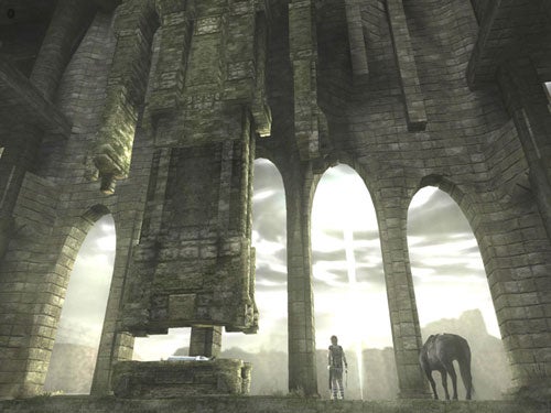 Screenshot from the video game Shadow of the Colossus showing the protagonist and a horse in front of ancient ruins with sunbeams filtering through the arches.