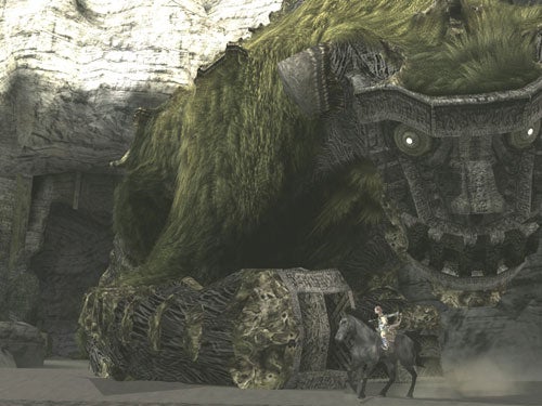 A screenshot from the video game Shadow of the Colossus showing a player character on horseback confronting one of the colossal creatures, with the creature's detailed furry texture and ancient, rocky armor prominently displayed.