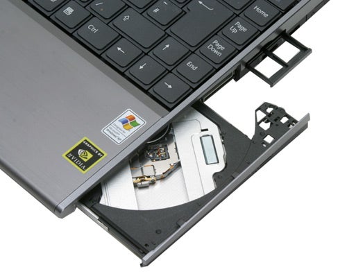 Sony VAIO VGN-SZ1VP laptop with open DVD drive showing internal components and keyboard.