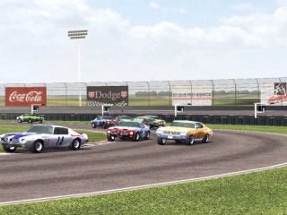 Screenshot from TOCA Race Driver 3 video game showing various race cars competing on a track with advertising banners in the background.