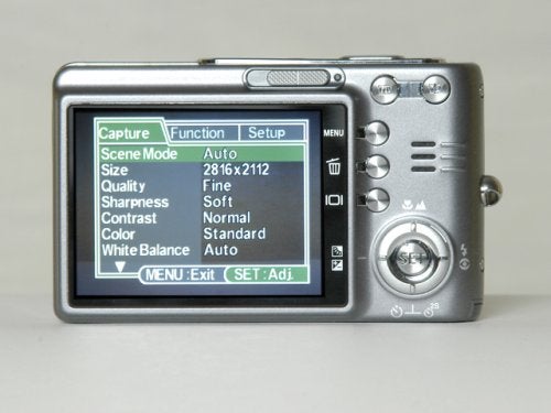 Acer CU-6530 digital camera displayed from the back showing the LCD screen with the menu options for scene mode, size, quality, sharpness, contrast, color, and white balance settings.
