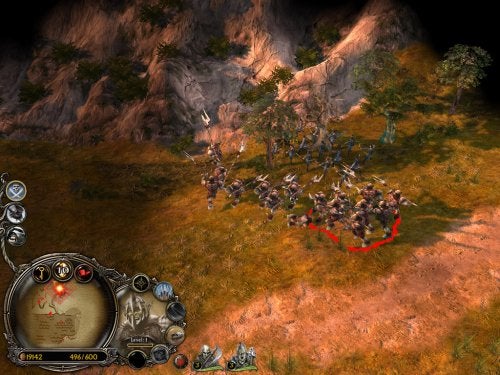 Screenshot of gameplay from Lord of the Rings: Battle for Middle Earth II showing an in-game battle scene with a group of soldiers near trees and a rocky landscape. The game's user interface is visible with resource counters and command buttons.