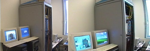 A panoramic view of an office space with computer workstations, as captured by the Panasonic WV-NP472E network camera, demonstrating the camera's wide-angle coverage.