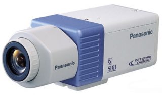 Panasonic WV-NP472E network camera with white and blue casing, featuring a prominent lens on the left side, and the Panasonic and SDII logos on the right.