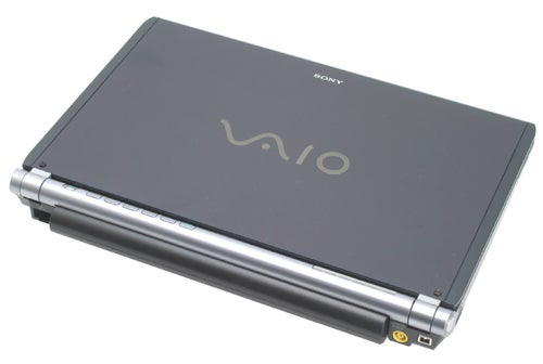 Sony VAIO VGN-TX2XP laptop closed, showcasing the dark casing with the VAIO logo on the lid, lying on a white surface.