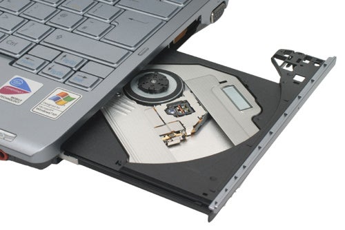 Sony VAIO VGN-TX2XP laptop with open optical drive displaying a CD and internal components on a white background.