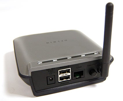 Belkin Wireless G Print Server with antenna and multiple ports visible, including USB and Ethernet, on a light background.