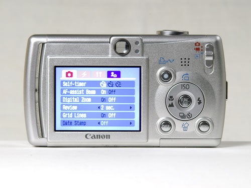 Canon IXUS Wireless digital camera displayed from the back showing its LCD screen with menu options visible.