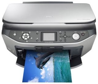 Epson Stylus Photo RX640 multifunction printer printing a high-quality color photo of a dolphin jumping out of the ocean.