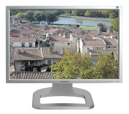 Samsung SyncMaster 244T monitor displaying a high-resolution scenic photograph of a town, showcasing the screen's color and clarity.