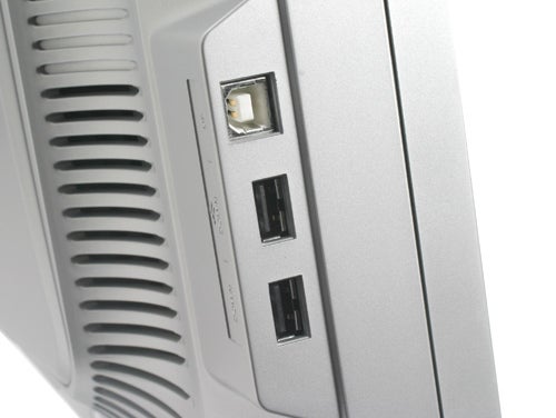 Close-up of the side panel of a Samsung SyncMaster 244T monitor displaying its USB ports and ventilation grille.