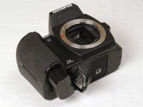 Olympus E-500 digital SLR camera without a lens attached, displaying the sensor and the open lens mount.