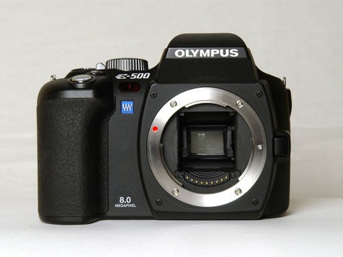 Olympus E-500 digital SLR camera without lens, showing its black body, mirror exposed inside the mount, and the 8.0-megapixel label on the grip.