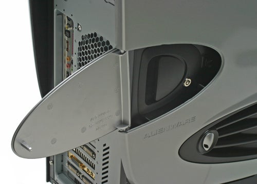 Close-up view of the side panel of a silver Alienware Aurora 7500 computer case with the panel open, revealing some ports and the Alienware logo.