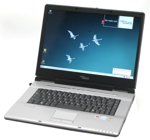 Fujitsu Siemens Amilo L1310G laptop open on a white background displaying a desktop wallpaper with flying birds, with company logo stickers on the top corner of the screen.