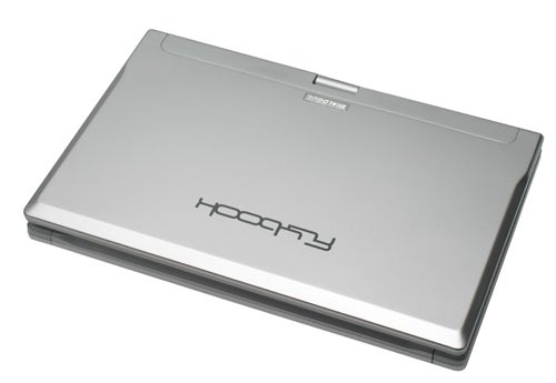 A Dialogue Flybook convertible laptop closed and facing down, showing the silver exterior with the brand logo at the center.