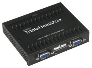 Matrox TripleHead2Go multi-monitor adapter with three VGA output ports and one VGA input port, showing the product logo and Matrox branding on a black chassis.