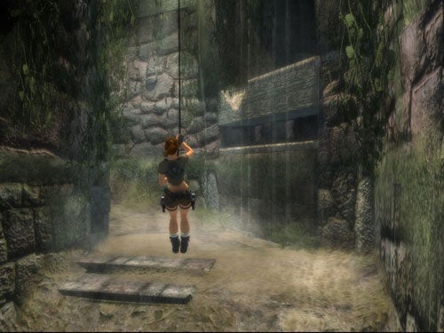 Screenshot from the video game Tomb Raider: Legend showing the main character Lara Croft from behind as she is about to swing on a rope in an ancient, ruinous environment.