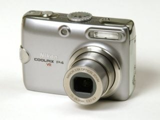 Nikon Coolpix P4 digital camera with lens extended, displaying the model name and 3.5x optical zoom details on the silver body.