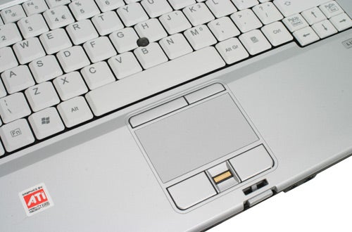 Close-up of the keyboard and touchpad area on a Fujitsu-Siemens LifeBook E8210 notebook with an ATI graphics sticker.