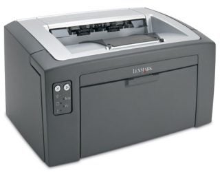 Lexmark E120n Mono Laser Printer on a white background, showcasing its compact design, front paper tray, control buttons, and the Lexmark logo.