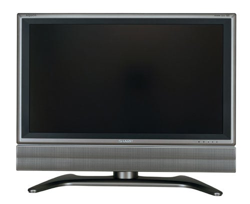 Sharp LC-32GD7E 32-inch LCD television with a black screen on a grey stand, featuring speakers at the bottom and the Sharp logo displayed on the lower front.
