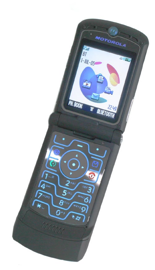 Motorola flip phone open and showing the main screen with a pie chart graphic, the date, and Bluetooth connectivity status.
