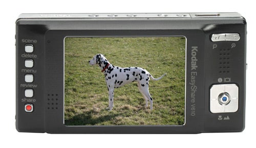 Rear view of a Kodak EasyShare V610 digital camera displaying a photo of a Dalmatian dog on its LCD screen.