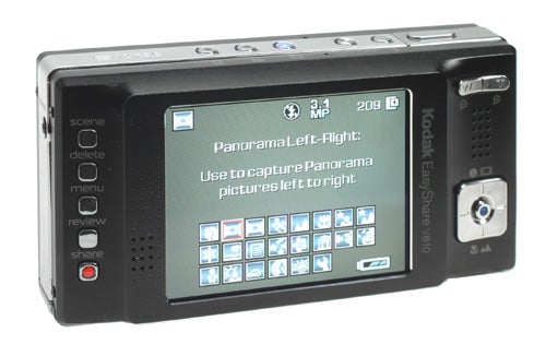 Kodak EasyShare V610 digital camera showing the back LCD screen with menu options and panoramic capture mode instructions.