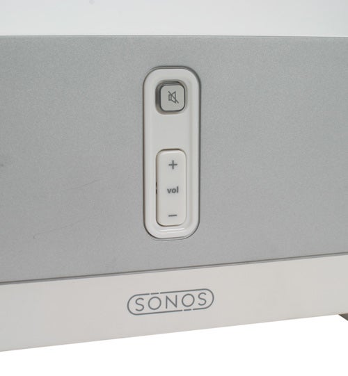 Close-up view of the Sonos ZP80 Digital Music System showing the volume control with plus and minus buttons, and the mute button above them, with the Sonos logo prominently displayed below.