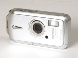 Pentax Optio W10 digital camera on a white background showing the front view with lens and waterproof label.
