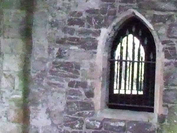 Photograph of a stone window frame in a historic building taken with a Fujifilm FinePix S5600, demonstrating the camera's low-light capability.