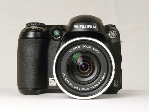 Fujifilm FinePix S5600 digital camera with a black body and a Fujinon zoom lens, displayed on a neutral background.