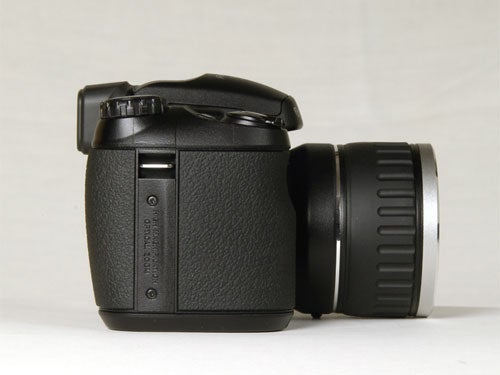 Fujifilm FinePix S5600 digital camera shown from a side angle with lens attached.