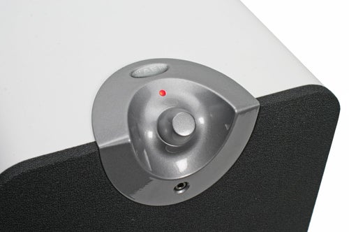 Close-up view of Acoustic Energy Aego M speaker with volume control and power indicator LED.